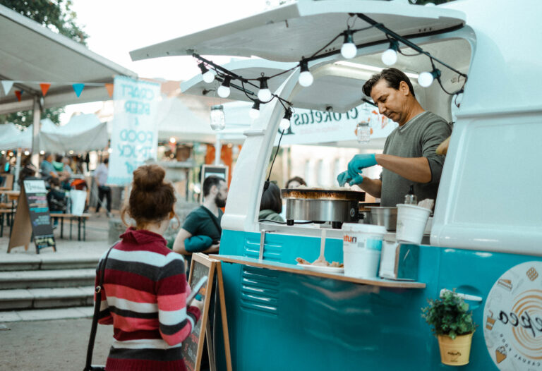 Serving food at a local market to a happy customer.