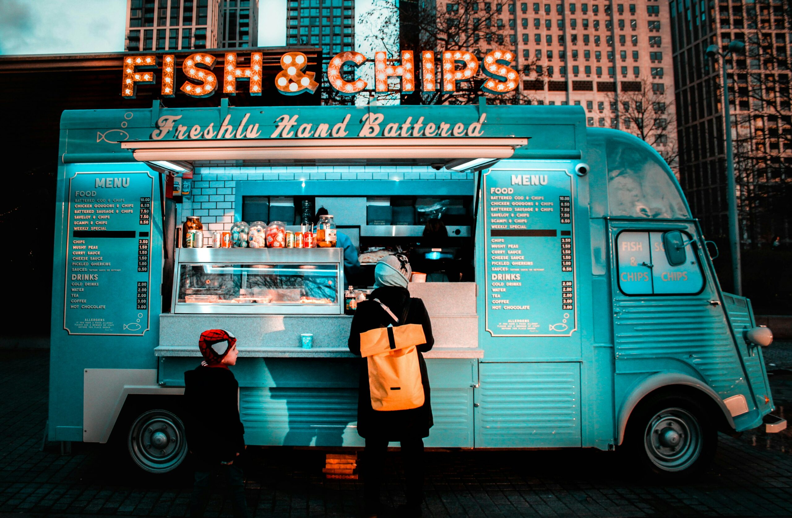 Fish & Chip Food Truck, lit up in neon lights. 
